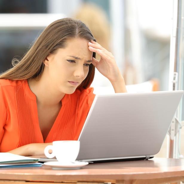 Worried entrepreneur reading bad news on line