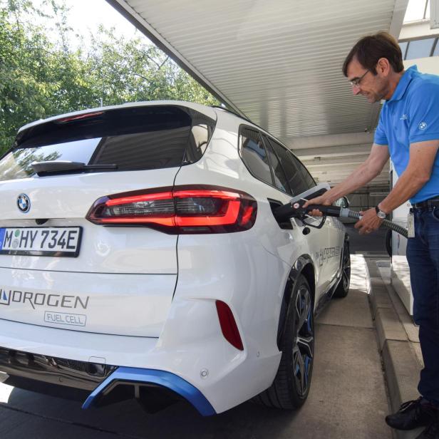 Juergen Guldner, a vice president at BMW in charge of the carmaker's hydrogen car program, fuels a hydrogen fuel-cell prototype SUV at a petrol station in Munich