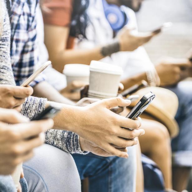 Multicultural friends group using smartphone with coffee at university college break - People hands addicted by mobile smart phone - Technology concept with connected trendy millennials - Filter image