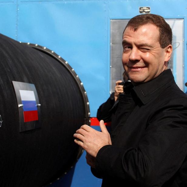 FILE PHOTO: Russian President Medvedev gestures after writing 'Good Luck!' on a pipe of the Nord Stream pipeline near Russian town of Vyborg