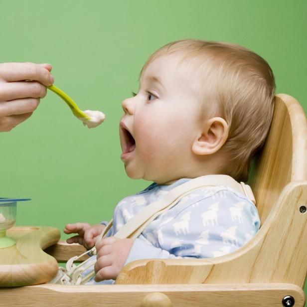 Adult feeding baby