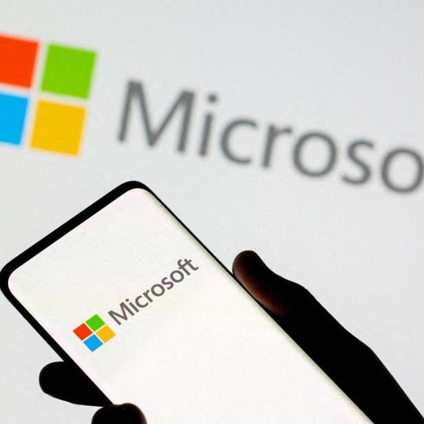 FILE PHOTO: Smartphone is seen in front of Microsoft logo displayed in this illustration taken