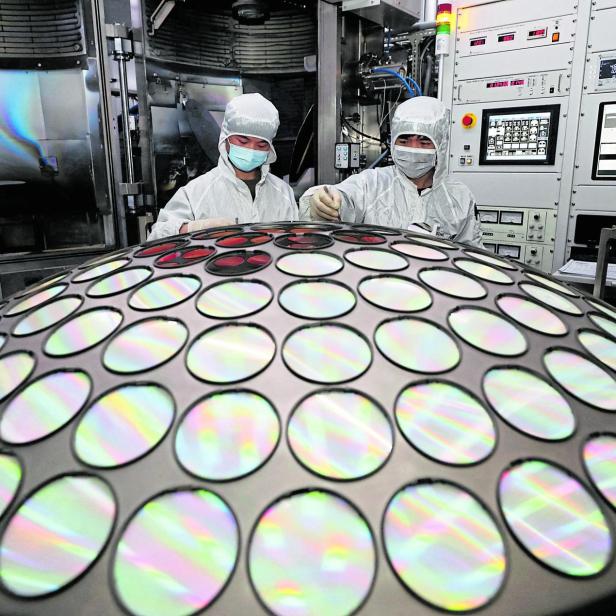 Employees work on the semiconductor chip production line of Jiangsu Azure Corp in Huaian