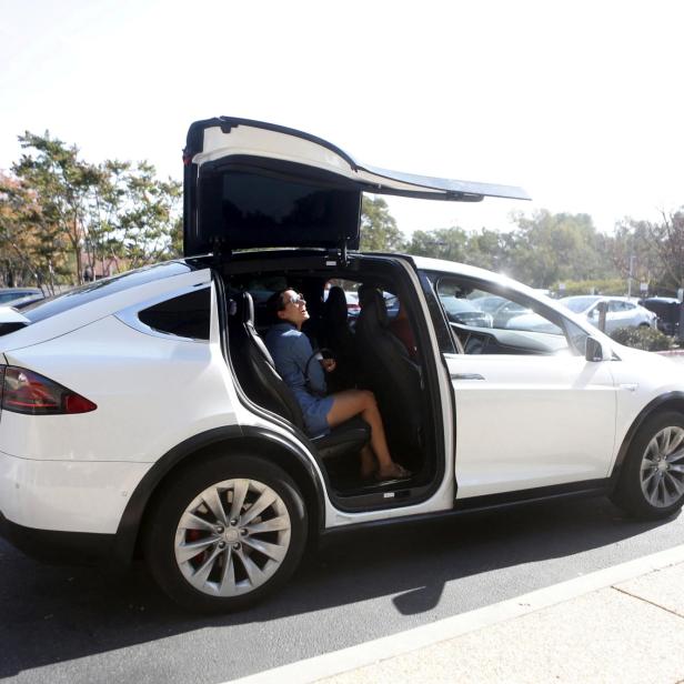 FILE PHOTO: A Tesla Model X picks up passengers during a Tesla event in Palo Alto, California