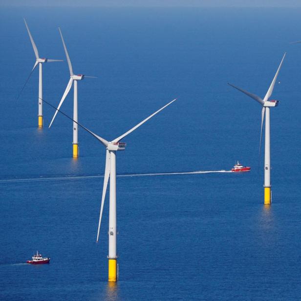 FILE PHOTO: A support vessel is seen next to a wind turbine at the Walney Extension offshore wind farm operated by Orsted off the coast of Blackpool