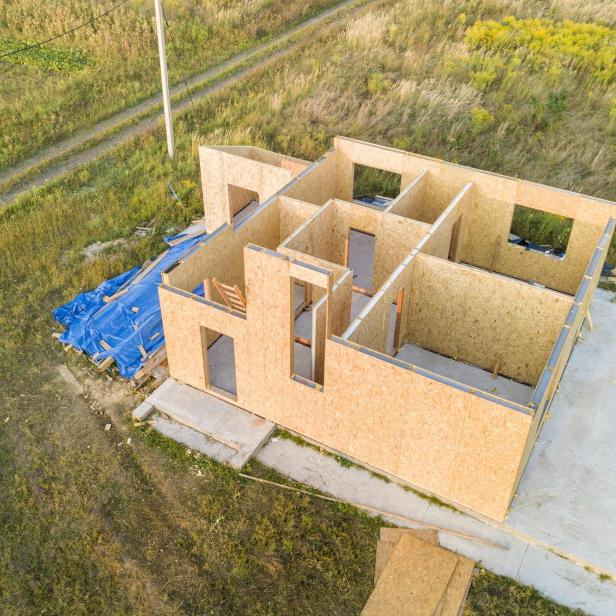 Construction of new and modern modular house. Walls made from composite wooden sip panels with styrofoam insulation inside. Building new frame of energy efficient home concept.