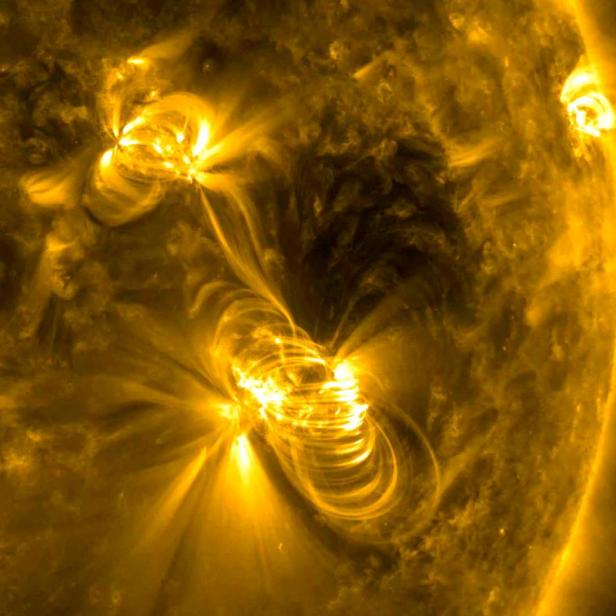 FILE PHOTO: NASA image of a medium-sized (M2) solar flare and a coronal mass ejection (CME) erupting from the same, large active region of the sun