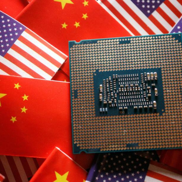 FILE PHOTO: Illustration picture of Chinese and U.S. flags with semiconductor chip