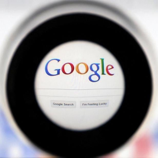 FILE PHOTO: A Google search page is seen through a magnifying glass in this photo illustration taken in Brussels