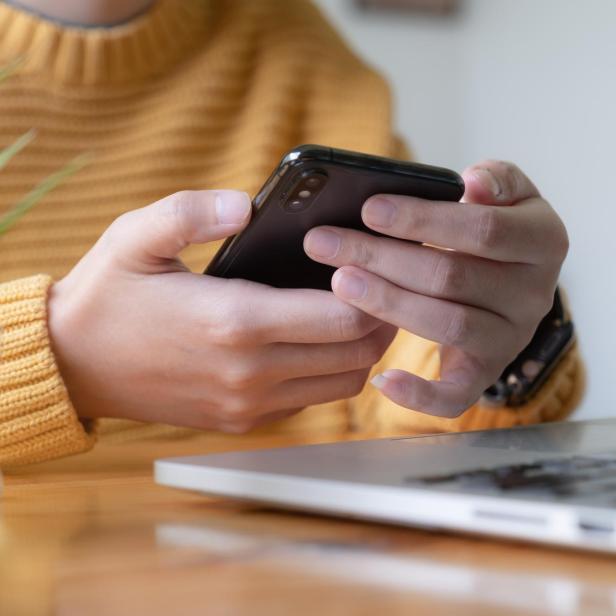 Young asian woman disconnect social and turn off her smartphone. Digital detox concept.