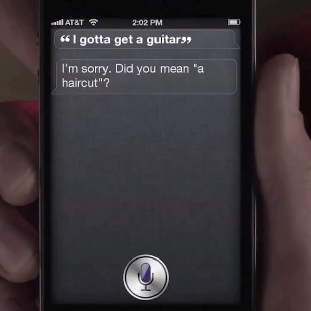 Ein Smartphone zeigt eine Konversation mit einem digitalen Assistenten, der „I gotta get a guitar“ falsch versteht.