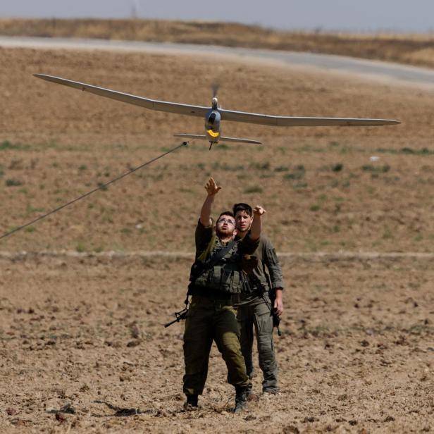 Israeli soldiers fly a drone near the Israel-Gaza border, in Israel