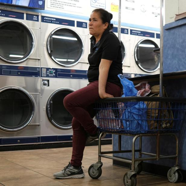 FILE PHOTO: A woman waits at a laundromat in downtown Los Angeles