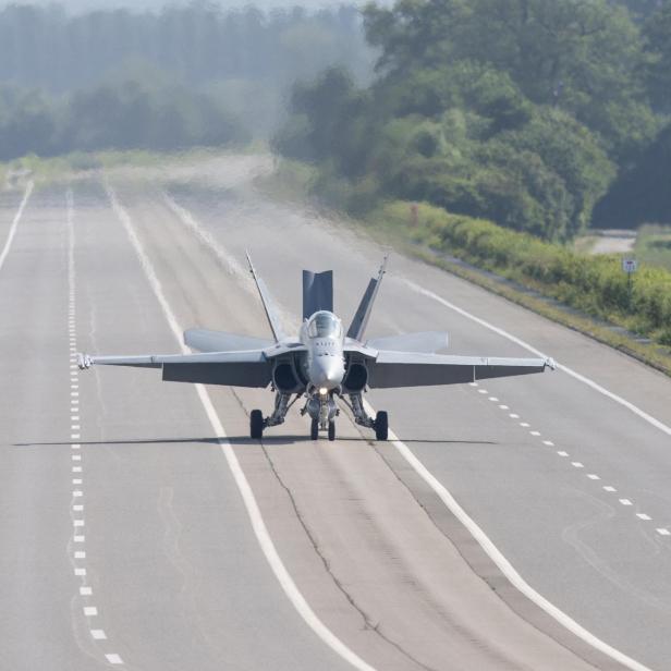 A Swiss Air Force F/A-18 fighter jet lands on the motorway during the Alpha Uno drill in Payerne