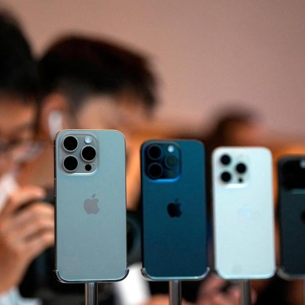 FILE PHOTO: People look at the new iPhone 15 Pro as Apple's new iPhone 15 officially goes on sale across China at an Apple store in Shanghai