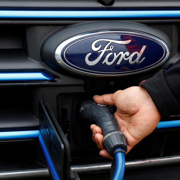 FILE PHOTO: Senior Courier for DHL, Christopher Brownbill, removes the charging cable from a Ford E-Transit in London