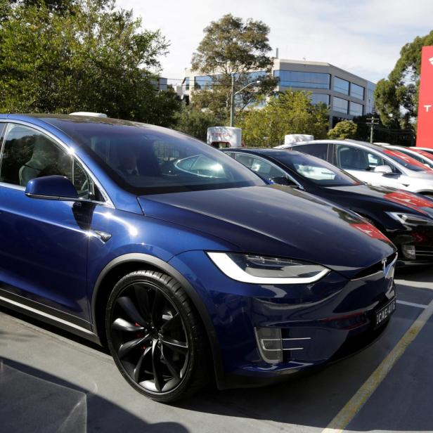 FILE PHOTO: A Tesla Model X car (front) and Model S (2nd L) are photographed at a Tesla electric car dealership in Sydney