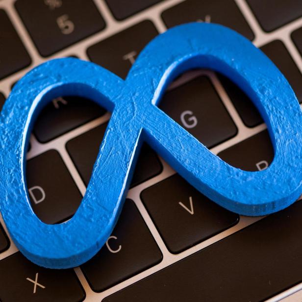 FILE PHOTO: A 3D printed Facebook's new rebrand logo Meta is placed on laptop keyboard in this illustration