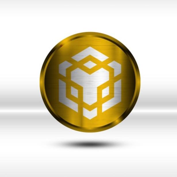 Eine goldene Münze mit einem Symbol auf weißem Hintergrund.