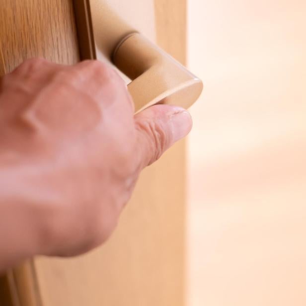 Human hand grabbing a doorknob