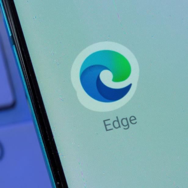 Microsoft Edge app is seen on the smartphone placed on the keyboard in this illustration