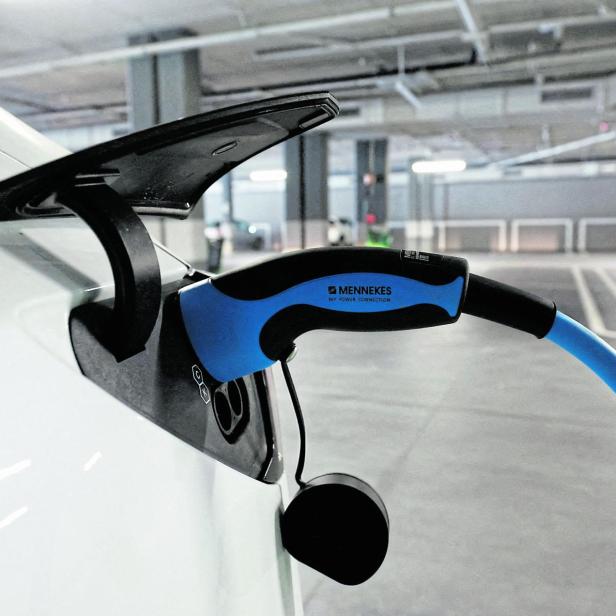 FILE PHOTO: A Tesla electric vehicle is being charged in a supermarket