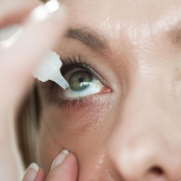 Woman usind eyedropper...applying eye drops