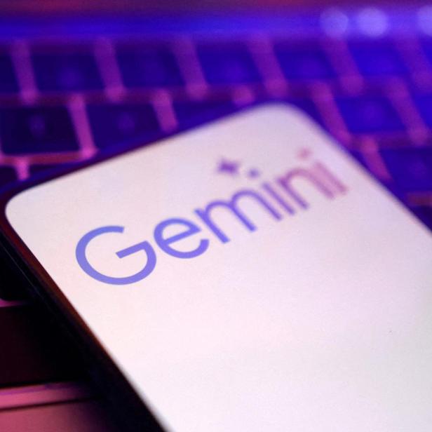 Ein Smartphone mit dem Gemini-Logo liegt auf einer Laptop-Tastatur.