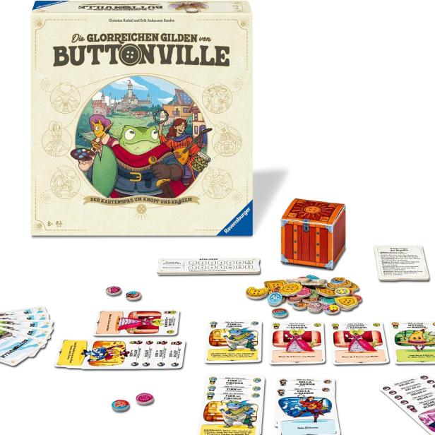 Spielschachtel von „Die glorreichen Gilden von Buttonville“ von Ravensburger mit Spielmaterial wie Karten, Chips und einer kleinen Schatztruhe auf einem Tisch.