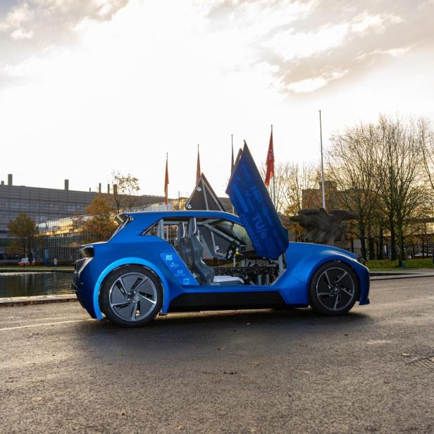 Blaues Aria E-Auto mit offener Tür auf der Straße