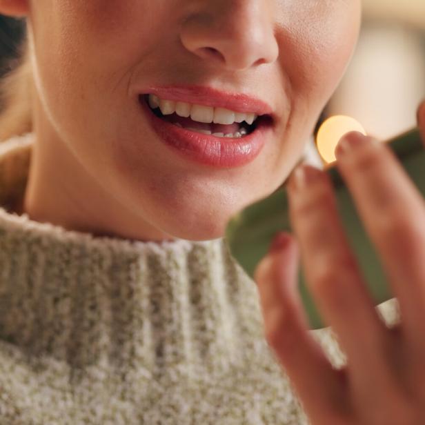 Woman, smartphone and home talking for voice note, recording and speaker or mic on mobile app or tech. Phone call, communication and audio message in apartment, voicemail and speech conversation