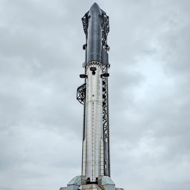 Die Starship-Rakete steht aufrecht auf der Startrampe unter bewölktem Himmel.