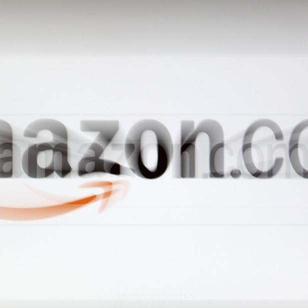 A zoomed image of a computer screen showing the Amazon logo is seen in Vienna in this November 26, 2012, file photo. Amazon.com Inc reported a second-quarter net loss and issued cautious third-quarter forecasts on July 25, 2013, pressuring shares of the world&#039;s largest Internet retailer. REUTERS/Heinz-Peter Bader/Files (AUSTRIA - Tags: POLITICS BUSINESS)